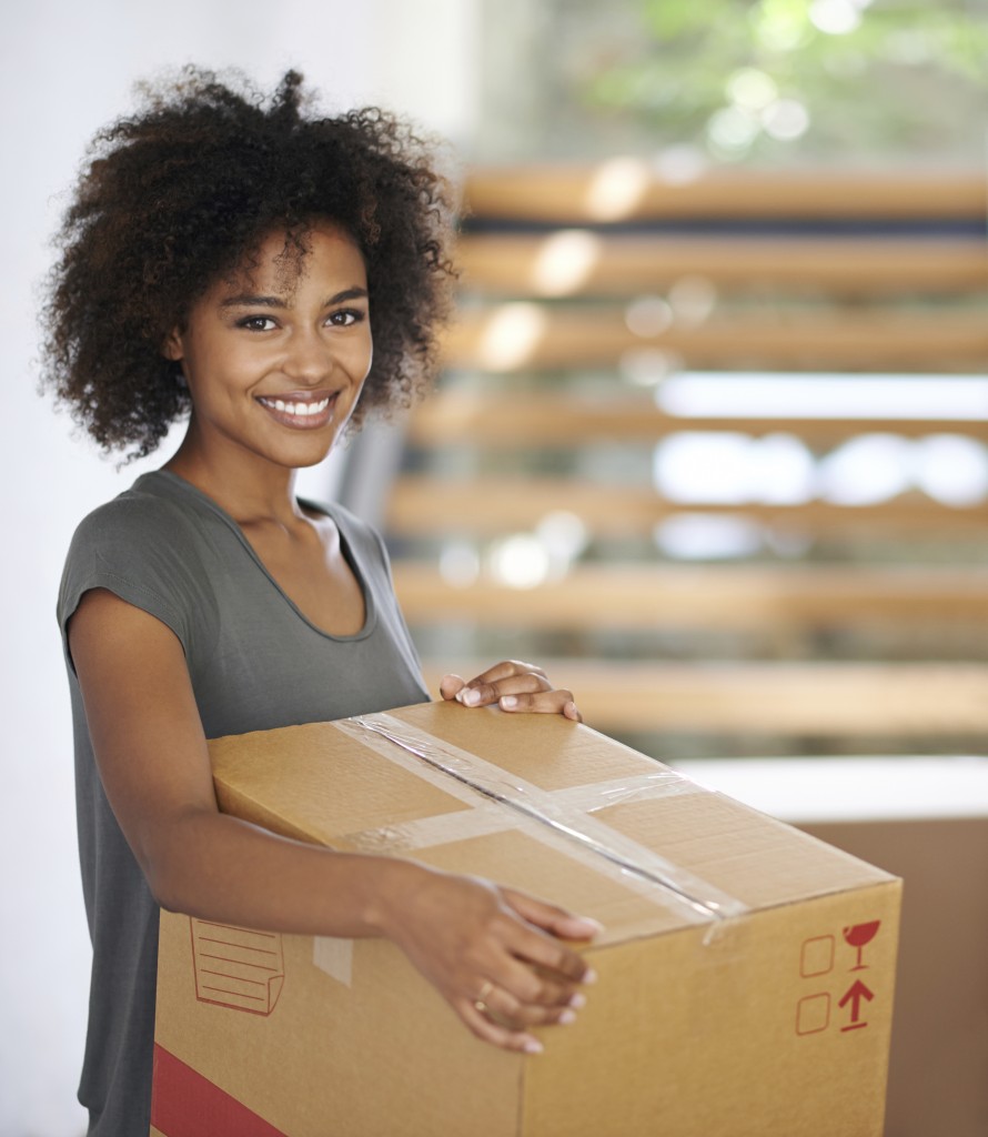 Portrait of a gorgeous young woman holding a box